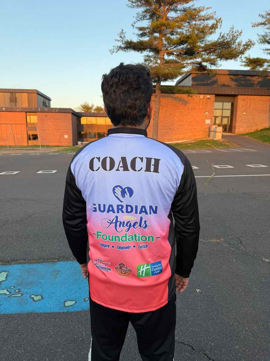 Coach wearing a Guardian Angels Foundation coach jersey