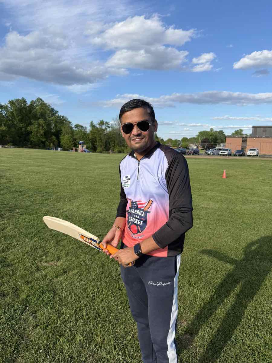 Coach holding a cricket bat