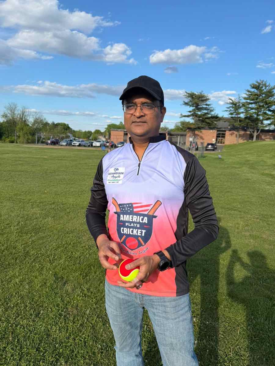 America Plays Cricket coach holding a ball