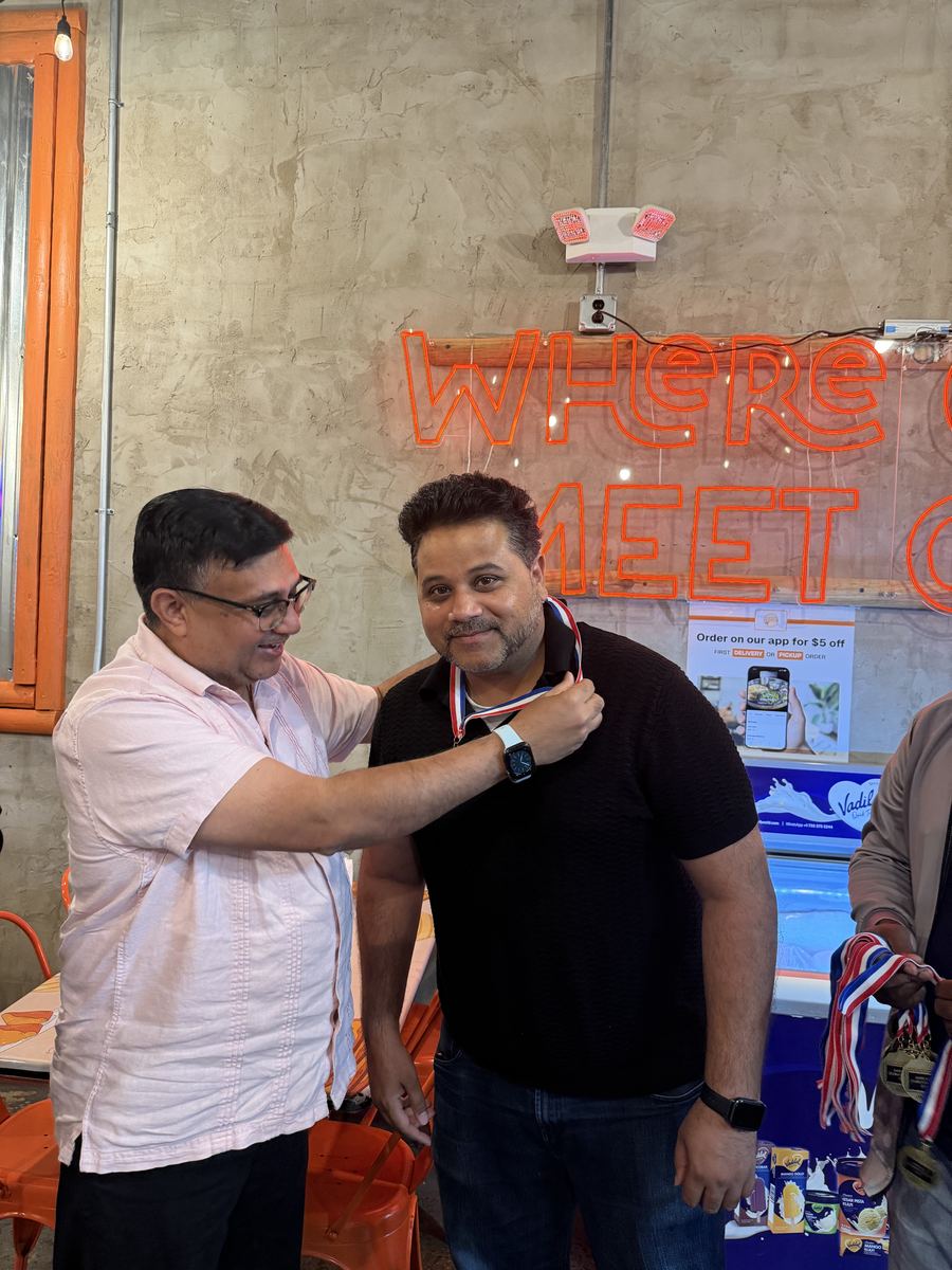 A medal being placed on a coach during the ceremony