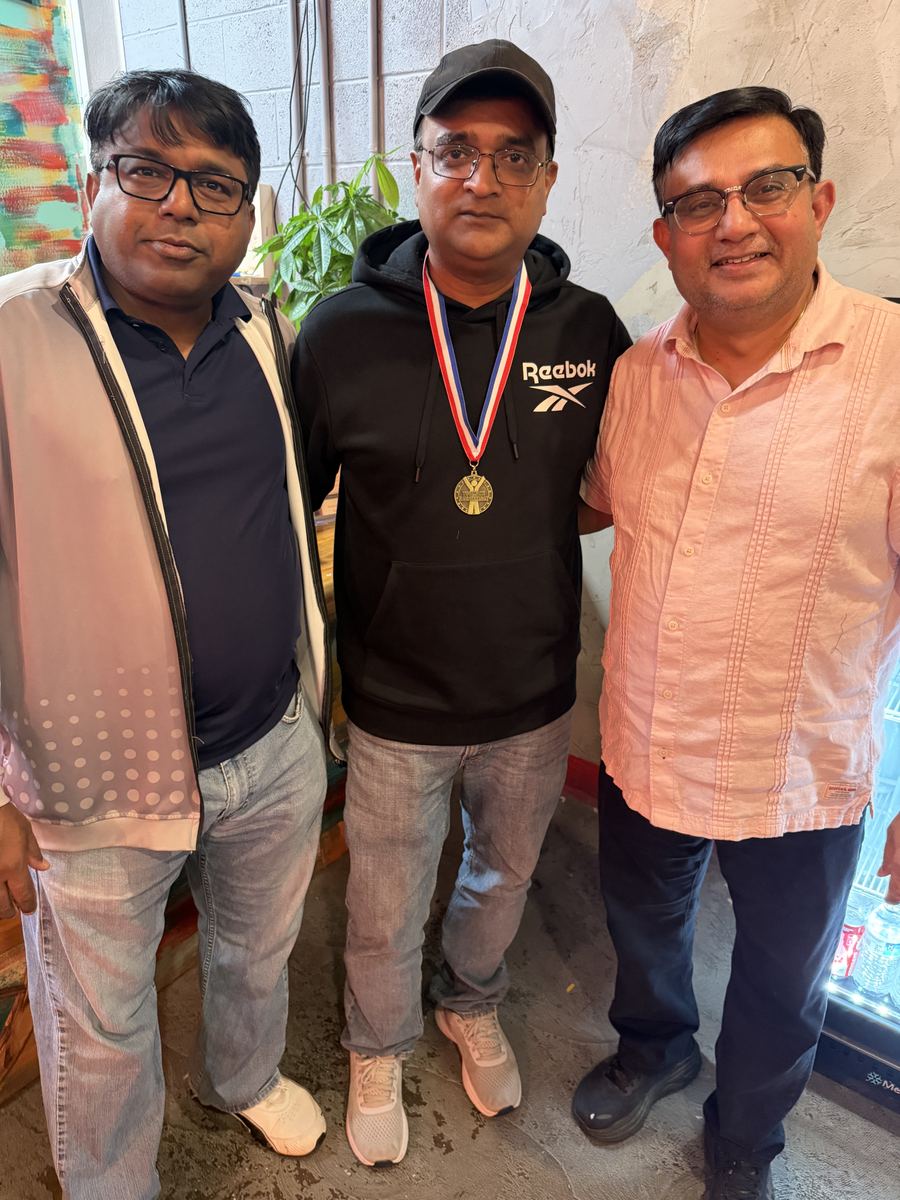 Coaches posing together with their medals