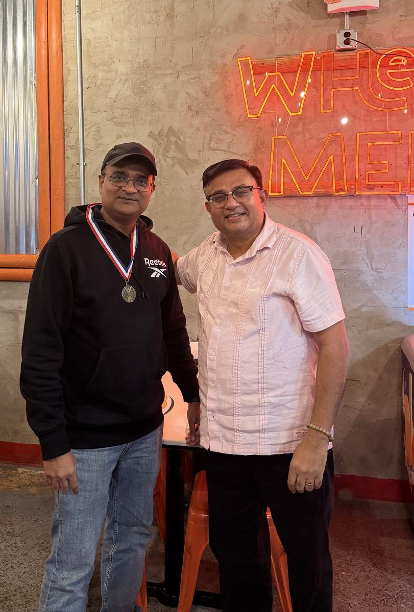 Two coaches posing together after the awards ceremony