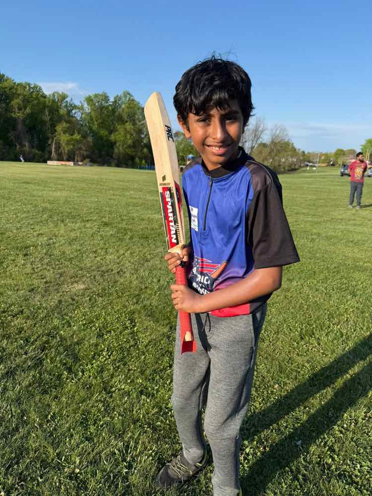 Young player smiling with his bat